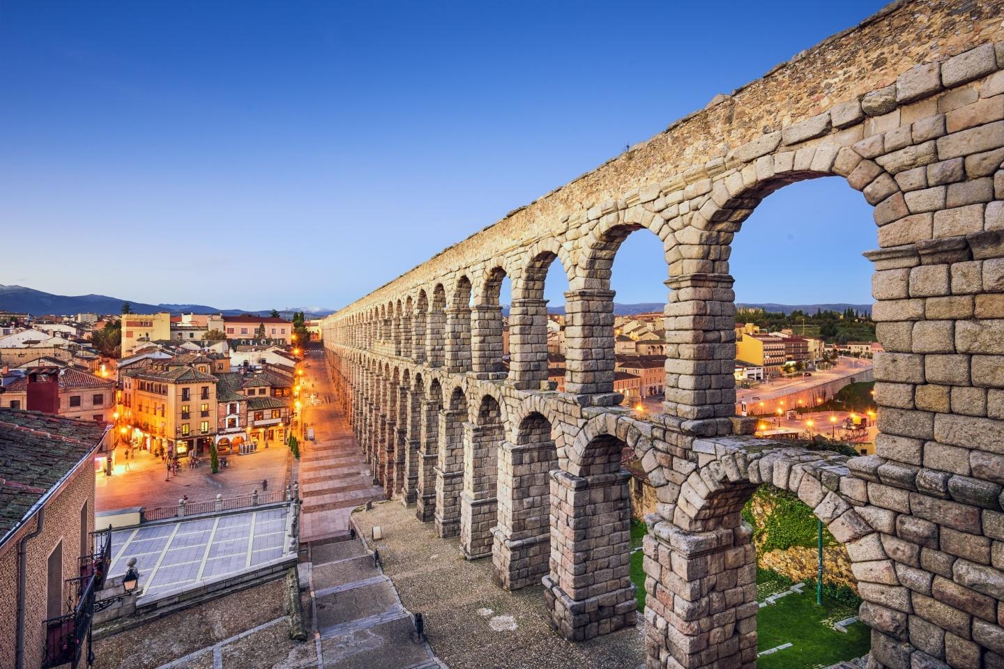 Sunset at the Aqueduct of Segovia, which was built by ancient Romans in Segovia, Spain