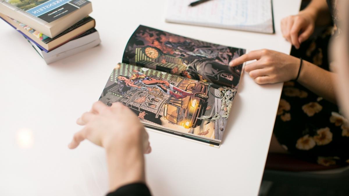 Students looking at comic book